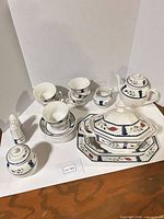 Full lot overview showing teapot, tureen, platters, cups, saucers, creamer, sugar, shakers