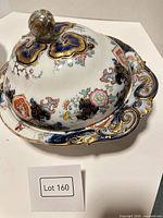 Covered porcelain dish with lid on underplate showing Imari decoration