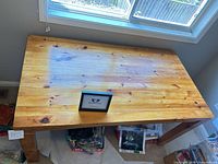 Top view of solid pine rectangular table showing surface wear