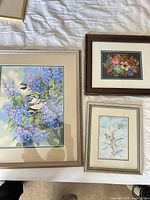 Front view of three framed artworks showing subjects and frames