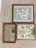 All three framed samplers on carpet