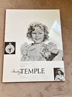 Front view of Shirley Temple poster showing main image and text