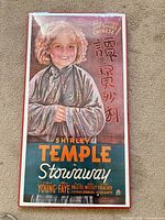 Front view of mounted Shirley Temple bilingual poster