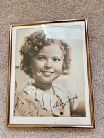 Front view of framed sepia portrait showing signature and frame