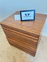 Front three-quarter view of nightstand showing top and two drawers