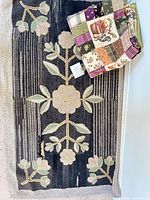 Hooked rug full view with folded quilt on corner