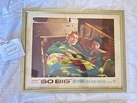 Front view of framed lobby card showing image and credits