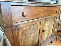 Front view showing full-width drawer and two paneled doors