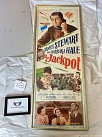 Front view of framed The Jackpot movie poster showing artwork and credits