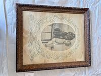 Front view of framed print showing child, dog, floral border and carved frame