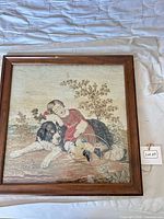 Front view of framed needlepoint showing full scene