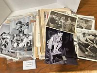 Overview of loose stacks of vintage publicity stills in open folder