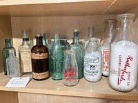 Wide view of all vintage bottles on shelf