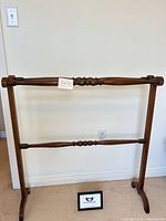 full front view of wooden two-rail quilt rack