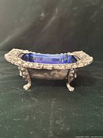 Side view showing footed holder and cobalt glass insert