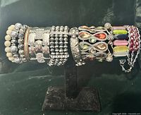 All bracelets displayed on stand showing variety of styles and materials