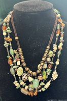 Both necklaces layered on display bust showing overall style and length