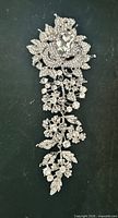 Full view of brooch showing overall cascading floral design