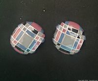 Front view showing geometric enamel design on both earrings