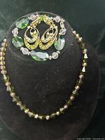 Full set on display bust showing necklace, bracelet and earrings together