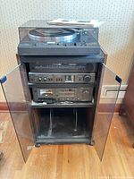 Full view of cabinet with turntable, tuner, amplifier, cassette deck stacked inside