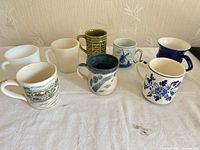 Group photo of all eight assorted mugs