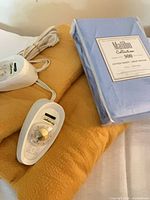 Electric blanket with controllers and packaged fitted sheet