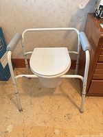 Front view of commode showing overall structure