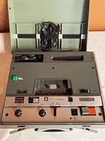 Recorder in open case with cord and cassette compartment visible