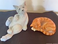 Both cat figurines side by side