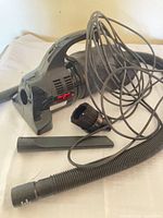 vacuum with hose, power cord, attachments