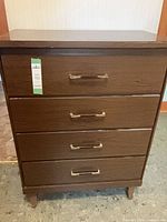 Front view of brown four-drawer dresser