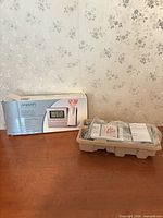 Box and packaged clock contents on table