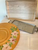 All three trays: wood-grain melamine tray, aluminum floral tray, painted lazy Susan