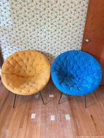 Front view of both rattan chairs showing cushions and legs
