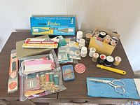 Overall view of all sewing accessories on table
