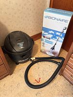 Shop-Vac vacuum beside boxed Bionaire steam mop