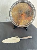 Tray on stand with pie server below