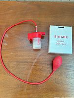 Complete Singer skirt marker kit with base, tube, bulb, and dispenser