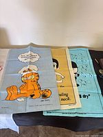Garfield, Kim, and bubbles tapestries laid flat