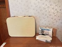 Suitcase front with Proctor Silex boxed iron and Jerome Alexander iron pouch