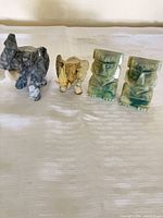 Group shot of both elephants and both stone bookends on table