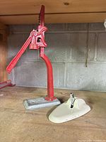 Full view of red bottle capper and beige GE device on shelf