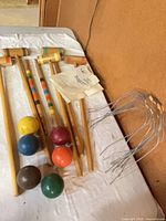 Mallets, stakes, balls and stacked wickets on table