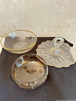 Overview of all three glass serving pieces on black cloth