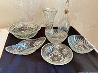 Overview of all seven cut glass pieces