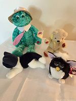 All four plush toys together on table