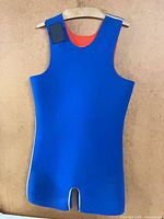 Front view of blue sleeveless wetsuit on hanger