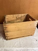 Front and side view of rectangular wood crate on cloth backdrop