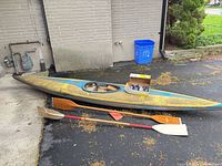 Full view of kayak, two paddles, Thule box
